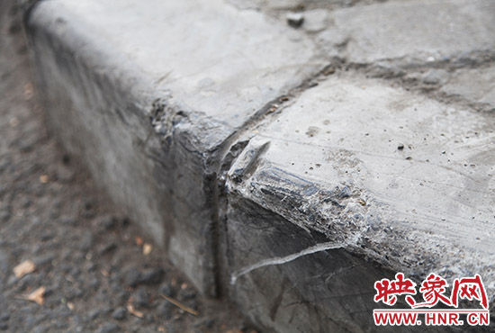 車(chē)道邊上的臺(tái)階，滿(mǎn)是電動(dòng)車(chē)摔下碰撞的痕跡