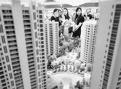 圖為近日，浙江杭州一家房產(chǎn)公司的兩位銷售人員一起向購房者介紹樓盤。新華社記者 王定昶攝