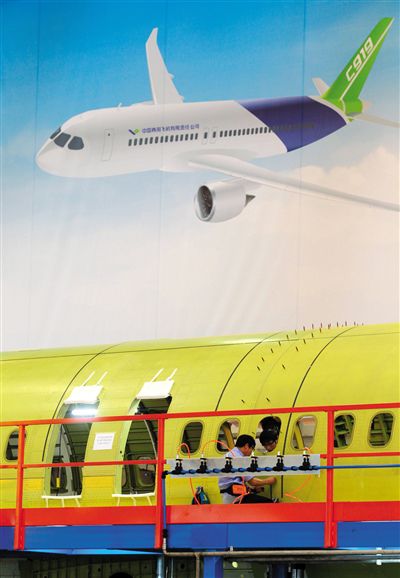 昨日，中國商飛總裝制造中心技術(shù)人員對(duì)接C919首架機(jī)的機(jī)體。新華社記者 丁汀 攝