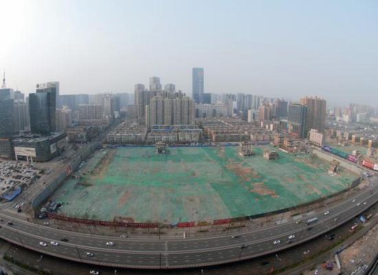 2016年4月，經(jīng)過持續(xù)攻堅，親賢社區(qū)西北片區(qū)的拆遷工作基本告一段落，但在鋪設(shè)了防塵綠網(wǎng)的空地中，至今仍有3戶居民選擇了“堅守”。(拍攝：2016年4月4日)