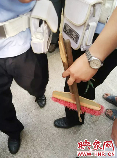 老太從環(huán)衛(wèi)工手中奪過(guò)掃帚，用腳踩斷，用力向環(huán)衛(wèi)工人的手上和腿上敲去。