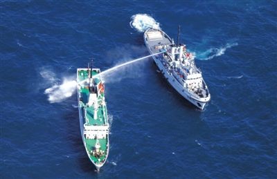 昨日，東海某海域，東海艦隊(duì)拖船使用高壓水炮為地方執(zhí)法船滅火
